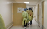 People in hallway wearing PPE