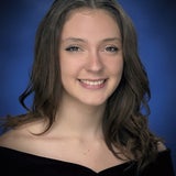 Teen with long brown hair and smiling
