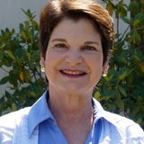 woman with short brown hair and is smiling