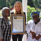 Resource family Betsy Rose and Paul Franklin being honored by Nicole Daly with a County of San Mateo Board of Supervisor's signed Resolution. 