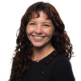 woman with long brown hair smiling