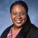 woman with long braids smiling