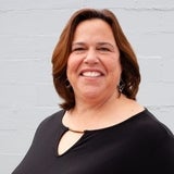 woman with brown shoulder length hair smiling