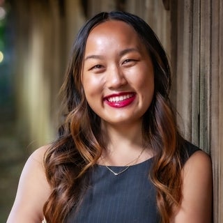 Ally Chan is an Asian American woman with long, straight brown hair.